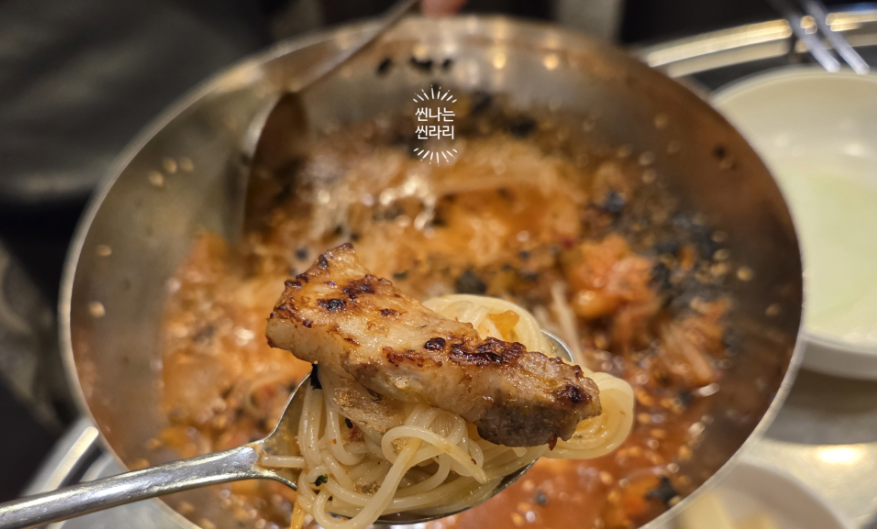 Grilled pork belly with kimchi noodles at the restaurant Dwaejine in Nakseongdae, Korea.