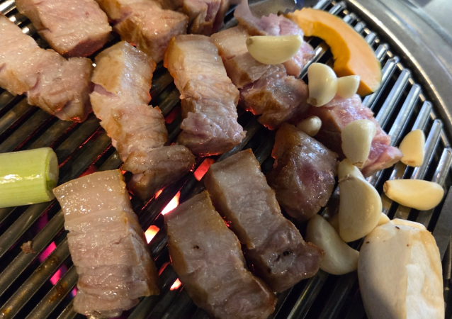 Korean pork belly or pork belly is being grilled deliciously on a grill(samgyeopsal and ogyeopsal.)
