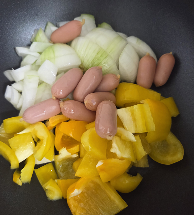 Onion, bell pepper and carrot prepared for Korean sausage stir-fry